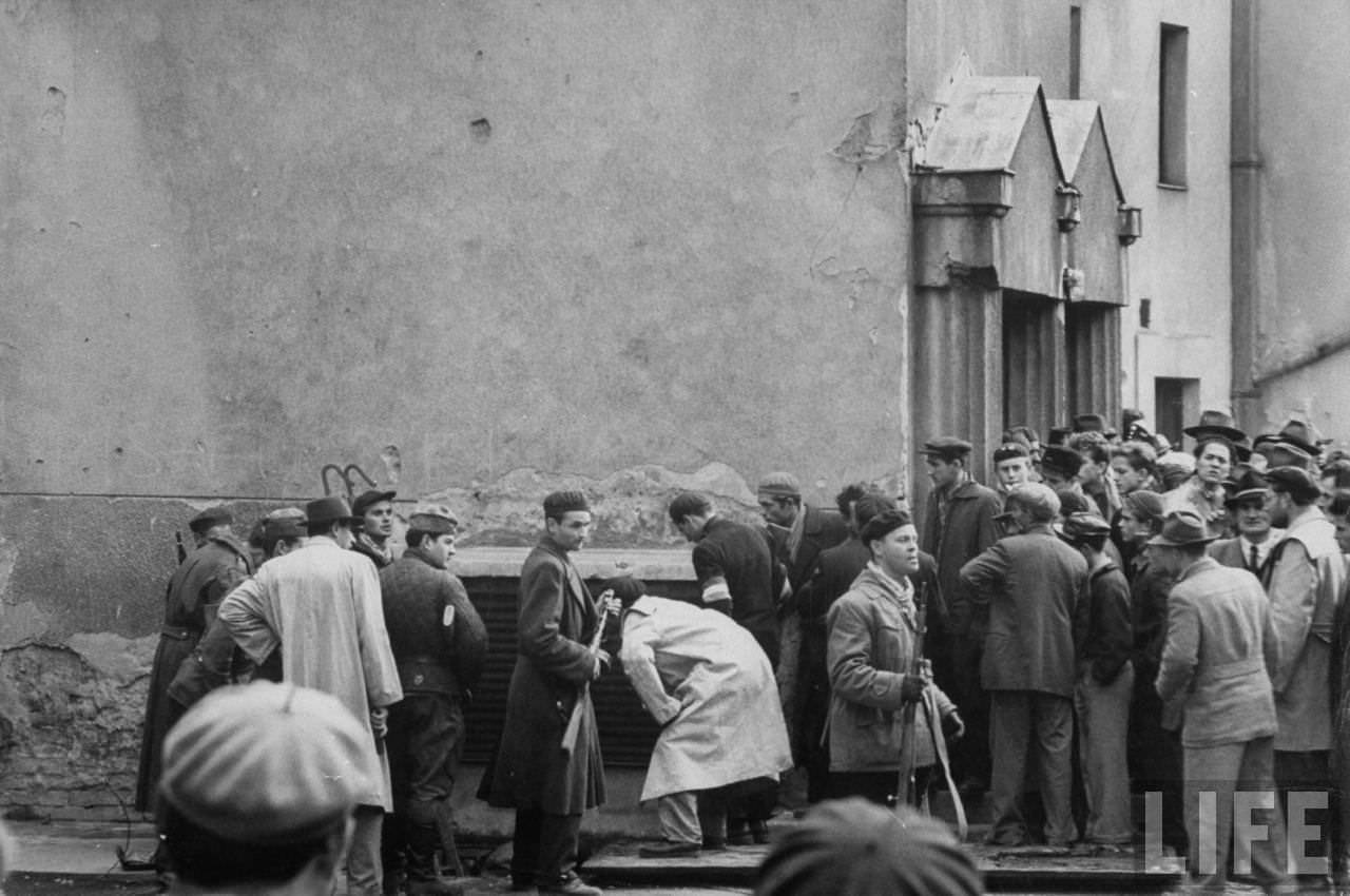 Hungarian Freedom Fighters gathered in the streets during revolution against Soviet-backed regime.