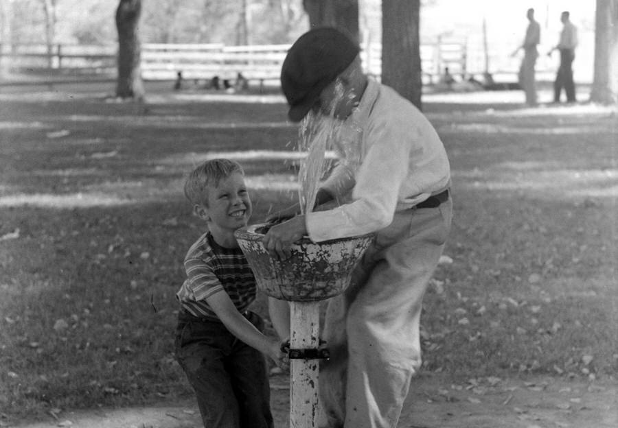 #2 Fun at the water fountain, picnic grounds, Vale, Oregon, July 4, 1941.