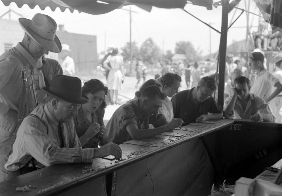 #24 Carnival rides in the background, Bingo players in foreground, Vale, Oregon, July 4, 1941.