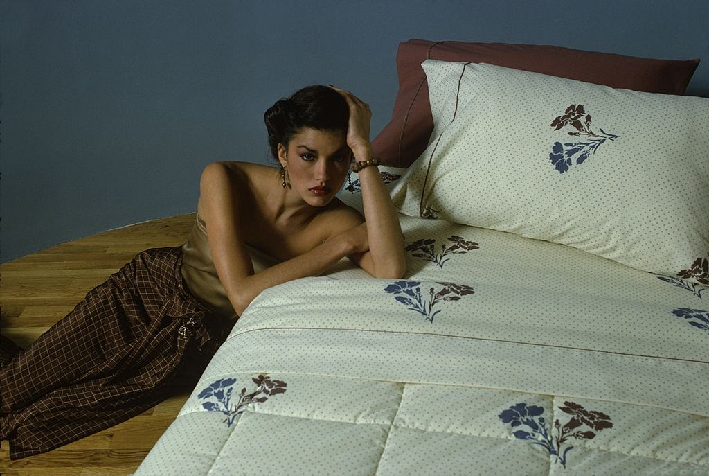 #15 Janice Dickinson dressed in a sleeveless, strapless, champagne-colored top and checkered brown silk trousers, 1978.