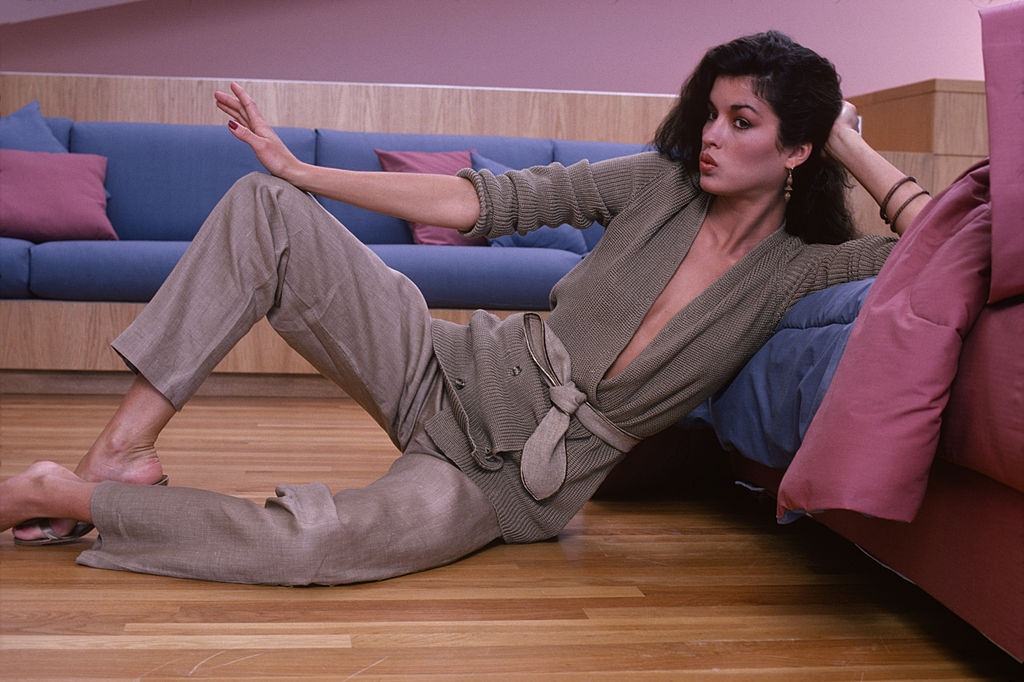 #18 Janice Dickinson in a belted, double-breasted sweater, 1978.