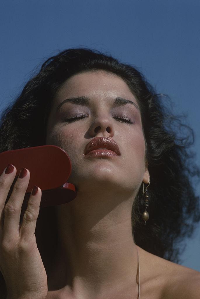 #20 Janice Dickerson as she holds a make-up compact in one hand, Amagansett. New York, October 1978.