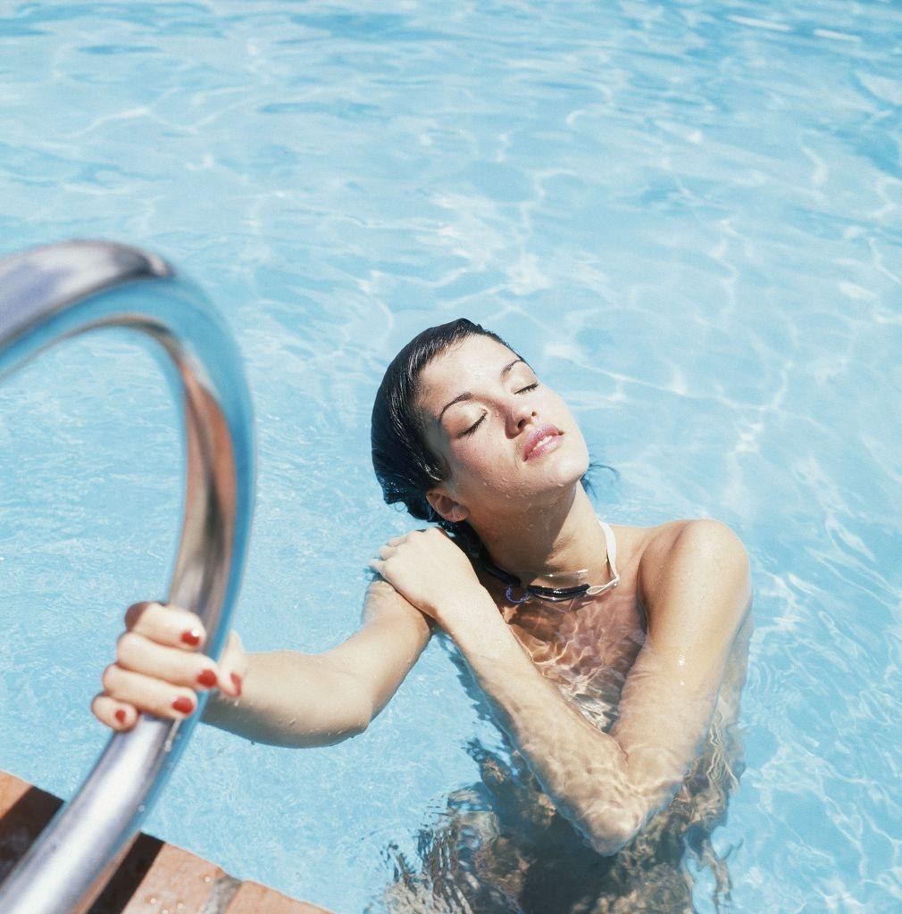 #26 Janice Dickinson in a swimming pool, 1979.
