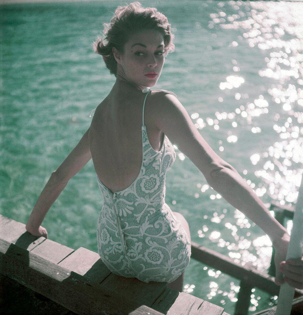 #2 Jean Patchett wearing a silk plaid woven in Siam coat over a lime-green silk dress, 1950.