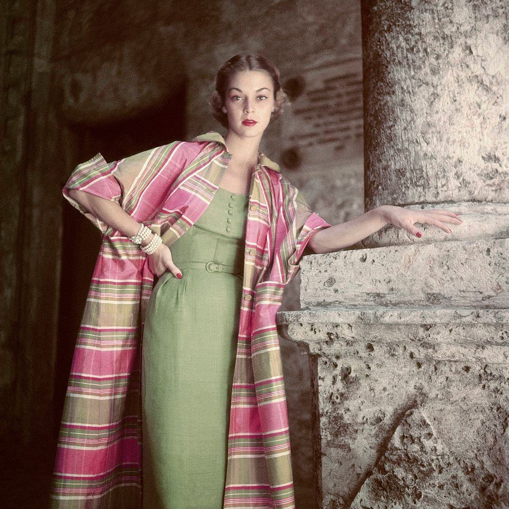 #3 Jean Patchett wearing a sunsuit and standing against a striped background, 1951.