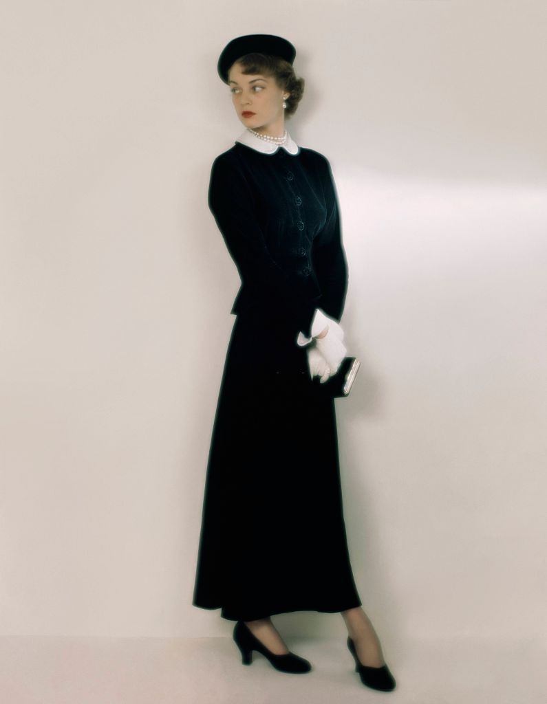 #5 Jean Patchett in a slender-skirted theatre suit in black taffeta and black velvet, 1948.