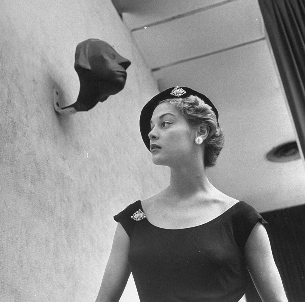 #8 Jean Patchett modeling huge Woolworth earrings, pearls, and rhinestone clips, 1949.