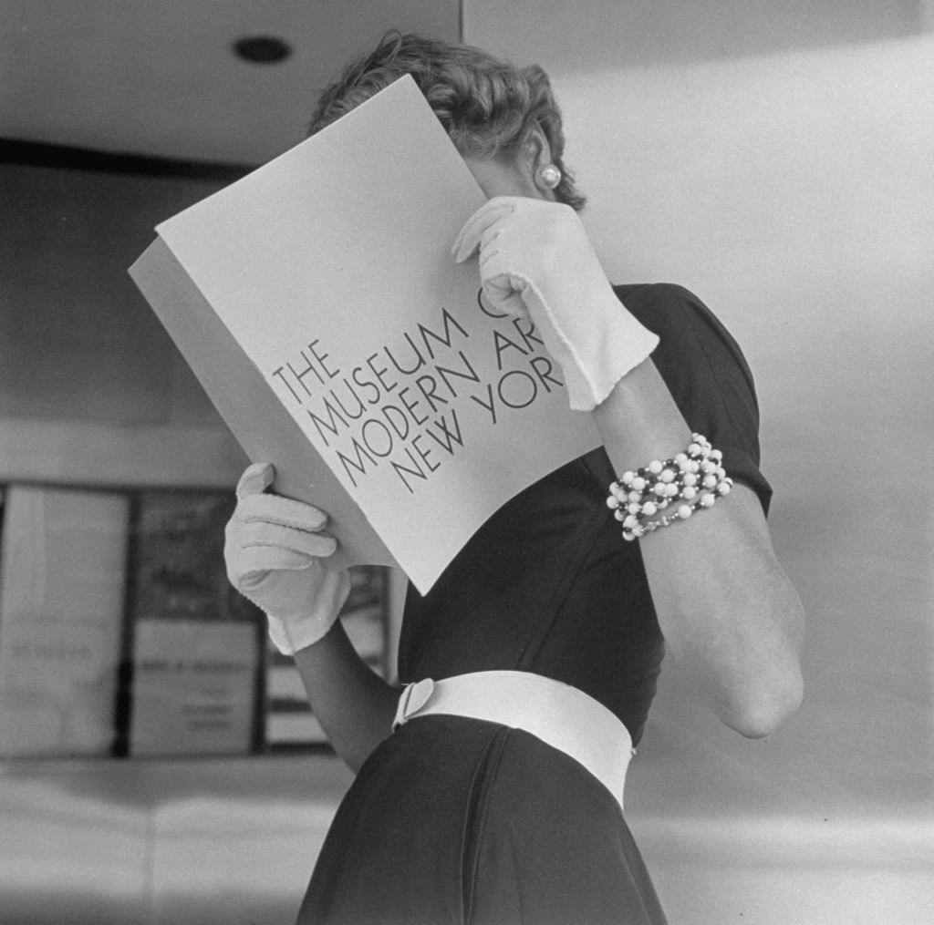 #10 Jean Patchett wearing white touches that set off expensive black dress, 1949.