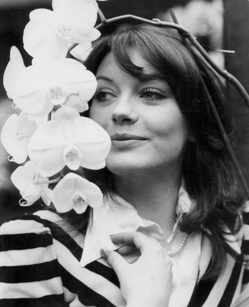 #21 Lesley-Anne Down with the hybrid orchid named after her, 1974.