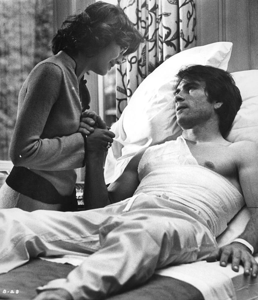 #43 Lesley-Anne Down comforts injured Tommy Lee Jones bedside in a scene from the film ‘The Betsy’, 1978.