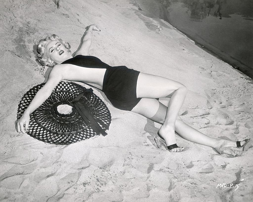 #71 Mamie Van Dore in black dress on the beach, 1953.