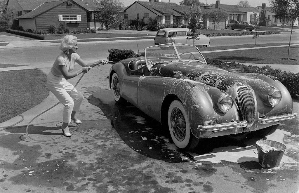 #17 Mamie Van Doren washing her Jaguar XK140 OTS sportscar, 1954.