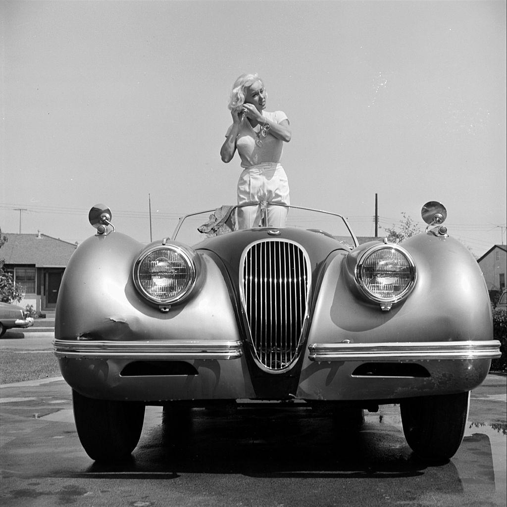#18 Mamie Van Doren in her Jaguar XK140 in Los Angeles, 1954.