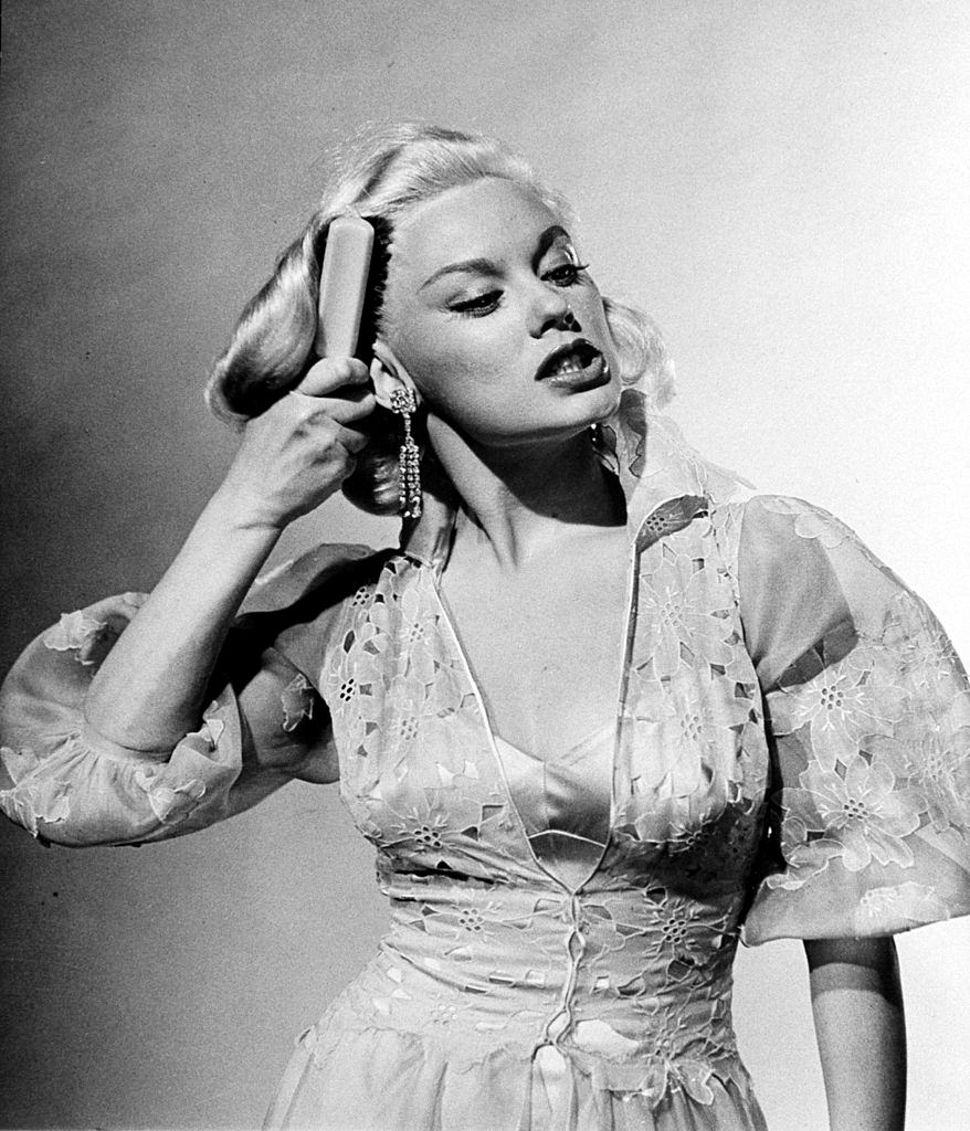 #31 Mamie Van Doren brushing her hair in anger during acting exercise, 1954.