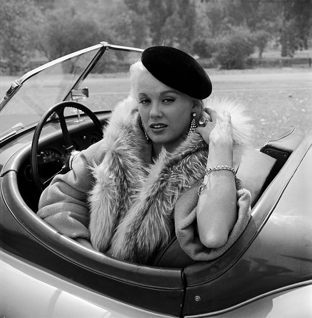 #59 Mamie Van Doren sitting in her Jaguar, 1955.