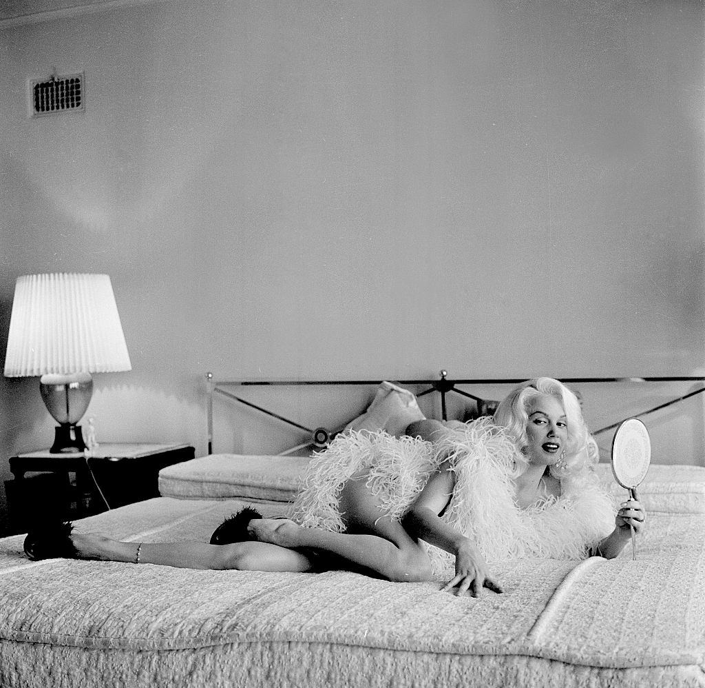 #23 Mamie Van Doren lying on the bed in her home at Los Angeles, 1956.