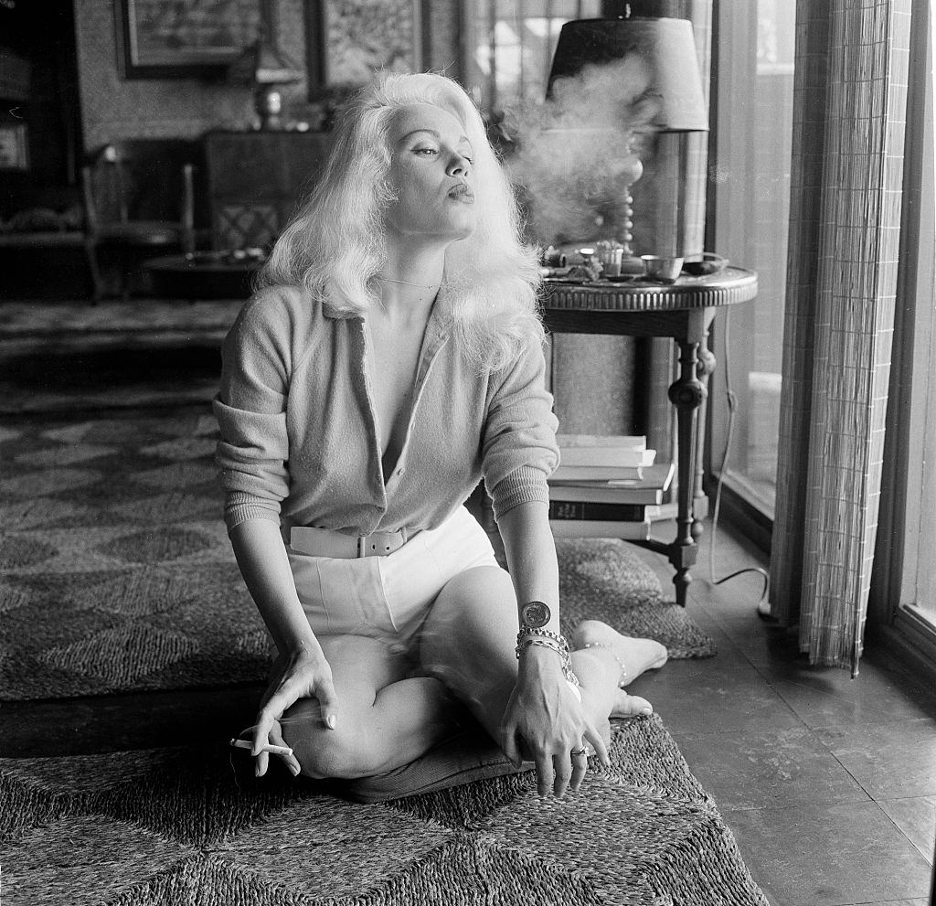 #13 Mamie Van Doren smoking a cigarette, 1956.