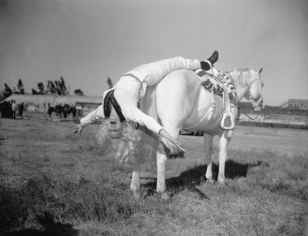 #56 Mamie Van Doren Hanging off Rear of Horse, 1957.