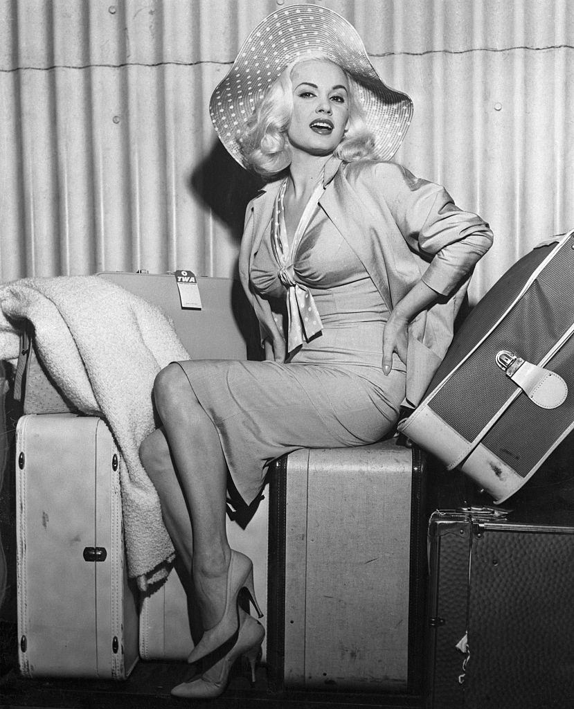 #45 Mamie Van Doren Sitting on Her Luggage, 1958.