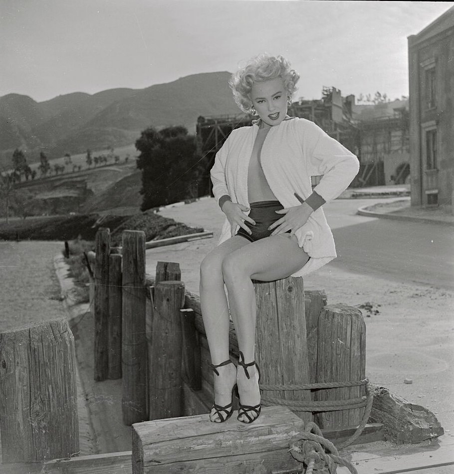 #51 Mamie Van Doren adds the proper ingredients here to a cheesecake photo, 1953.