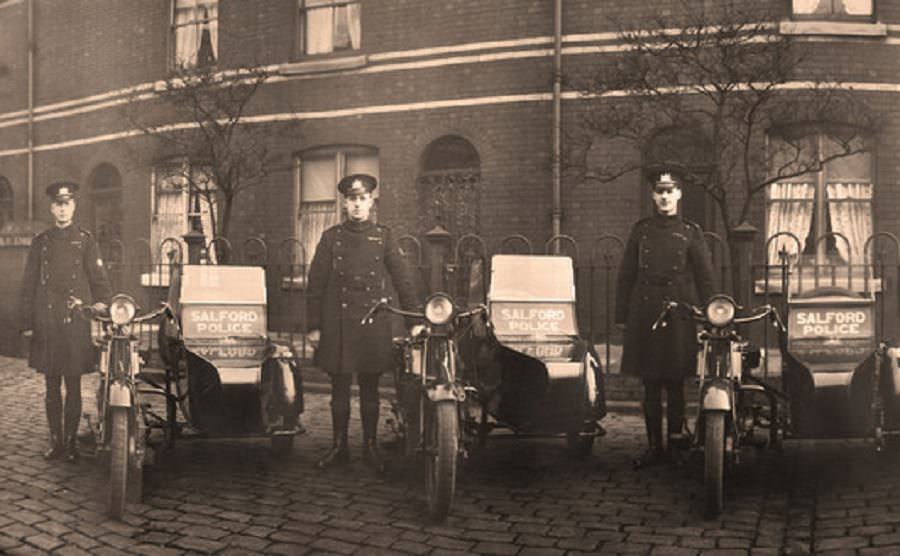 #75 Officers of Salford City Police pose proudly with their sidecars on a cobbled street, 1920s