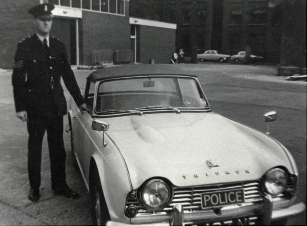 #22 A Manchester City Police sergeant stands proudly alongside his Triumph TR4 patrol car in the yard of Longsight Police Station in the 1960s