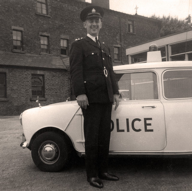 #28 Manchester City Police’s Inspector Albert Leach stands beside a Mini Cooper S patrol car sometime during the mid 1960s.