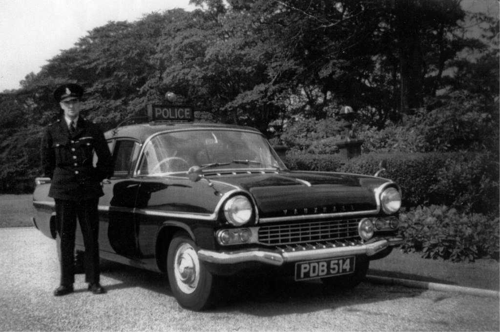 #1 An officer of Stockport Borough Police stands proudly besides his Vauxhall Velox vehicle in Stockport’s Woodbank Memorial Park , 1962