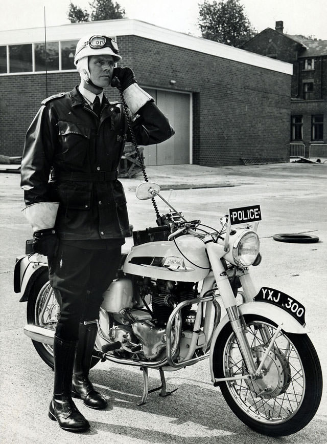 #37 An officer of Manchester City Police test the radio on his Norton Atlas police motorcycle in the yard of Longsight Police Station prior to going out on patrol, 1963