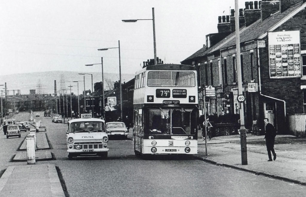 #43 A Ford Transit police van overtaking a number 77 bus on a North Manchester road in the early 1970s