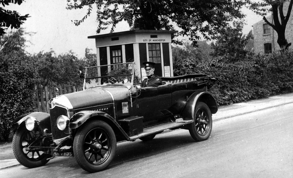 #77 A Manchester City Police vehicle sits outside one of the force’s police boxes in the 1930s