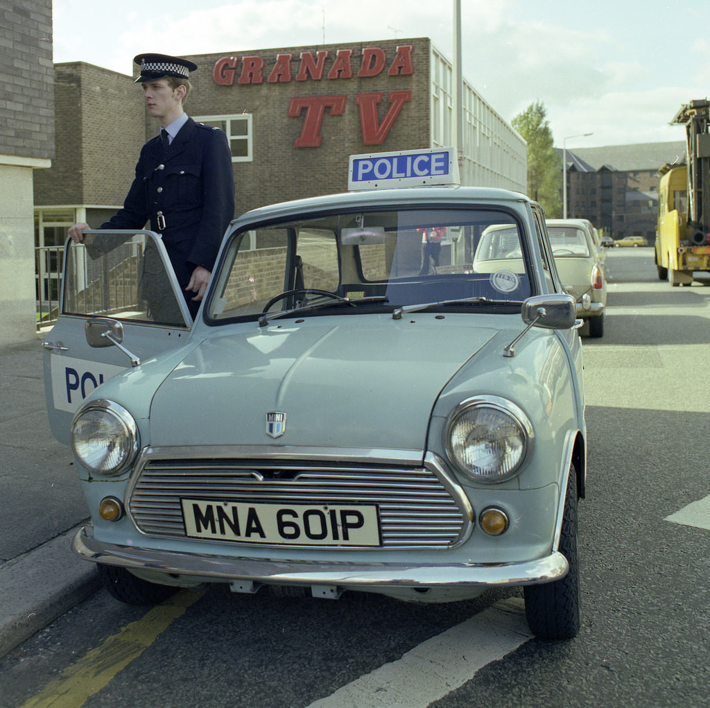 #54 A Greater Manchester Police officer and his Mini patrol car outside part the Granada Television complex on Quay Street in Manchester, 1977