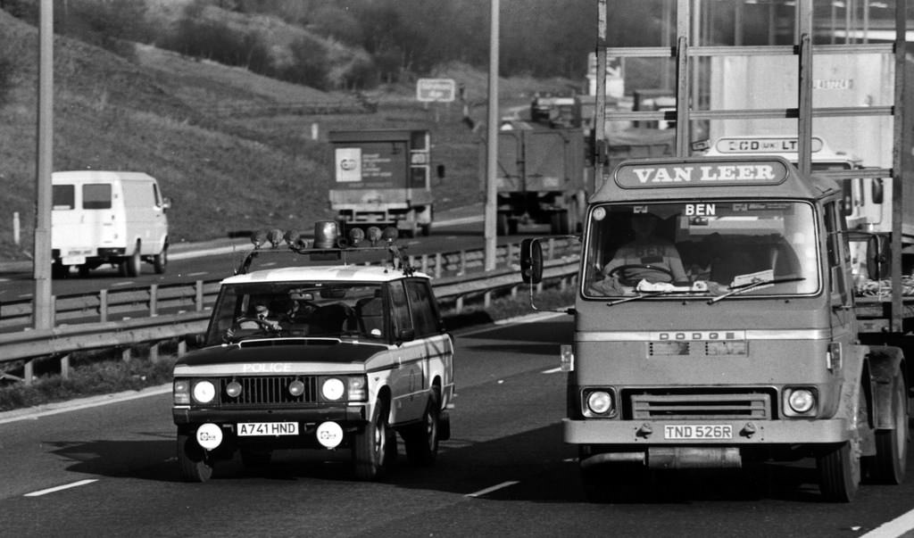 #65 A Range Rover of Greater Manchester Police’s Motorway Unit overtakes a Dodge lorry while on patrol in 1984
