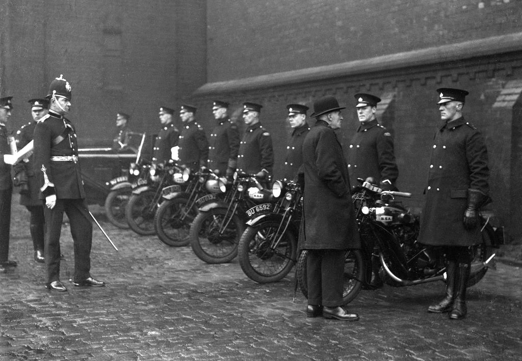 #8 The chief constable of Oldham Borough Police watches an inspection of the force’s motorcyclists, 1935.