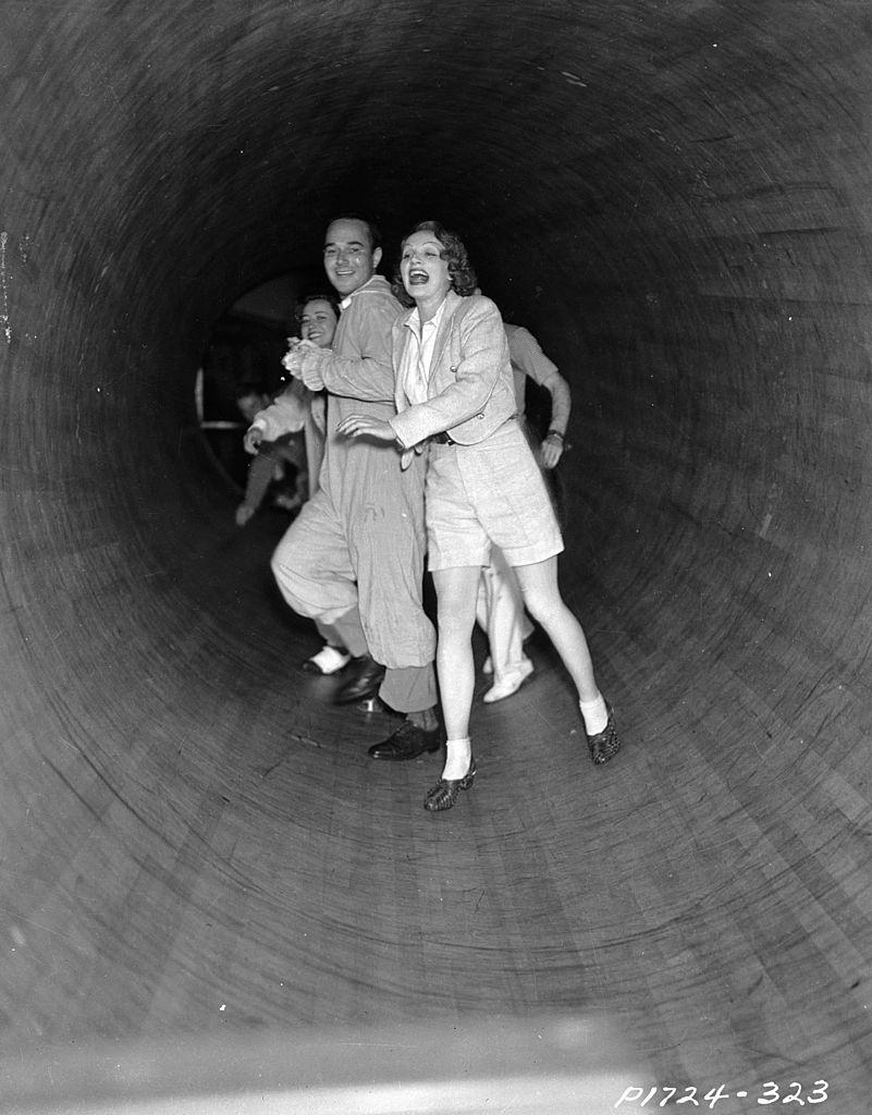 #72 Marlene Dietrich attempt to stay upright in a spinning tunnel, 1930.
