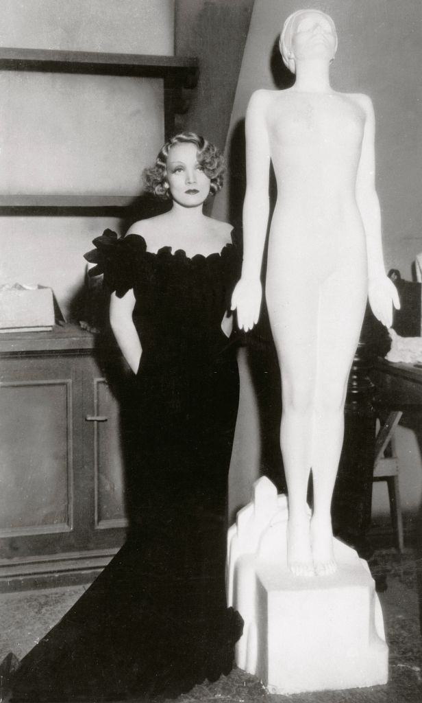 #69 Marlene Dietrich with a statue created for her film in 1930s.