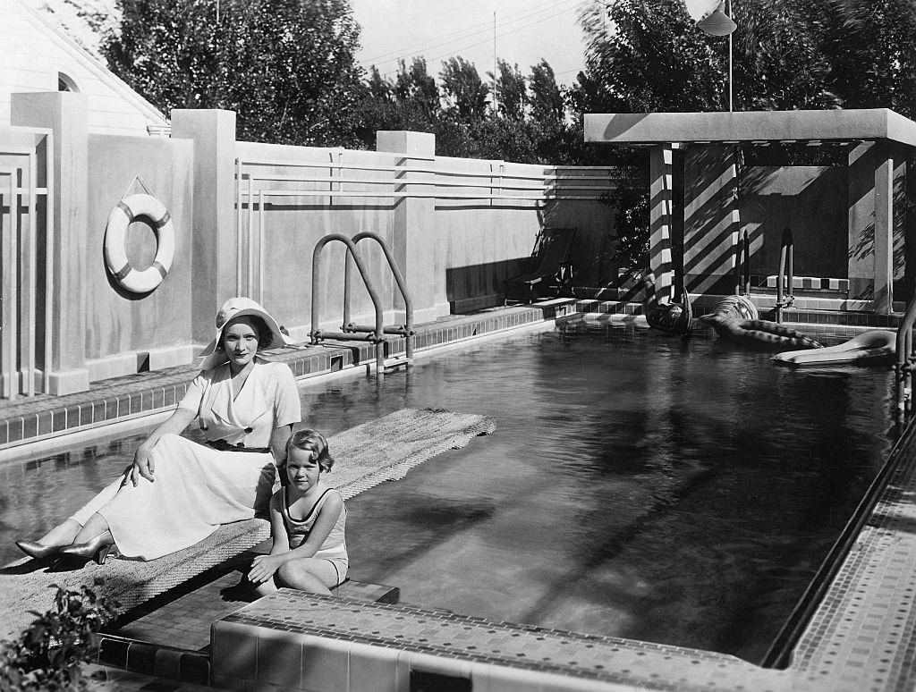 #14 Marlene Dietrich with her daughter Maria at the swimming pool of her villa in Hollywood , 1931.