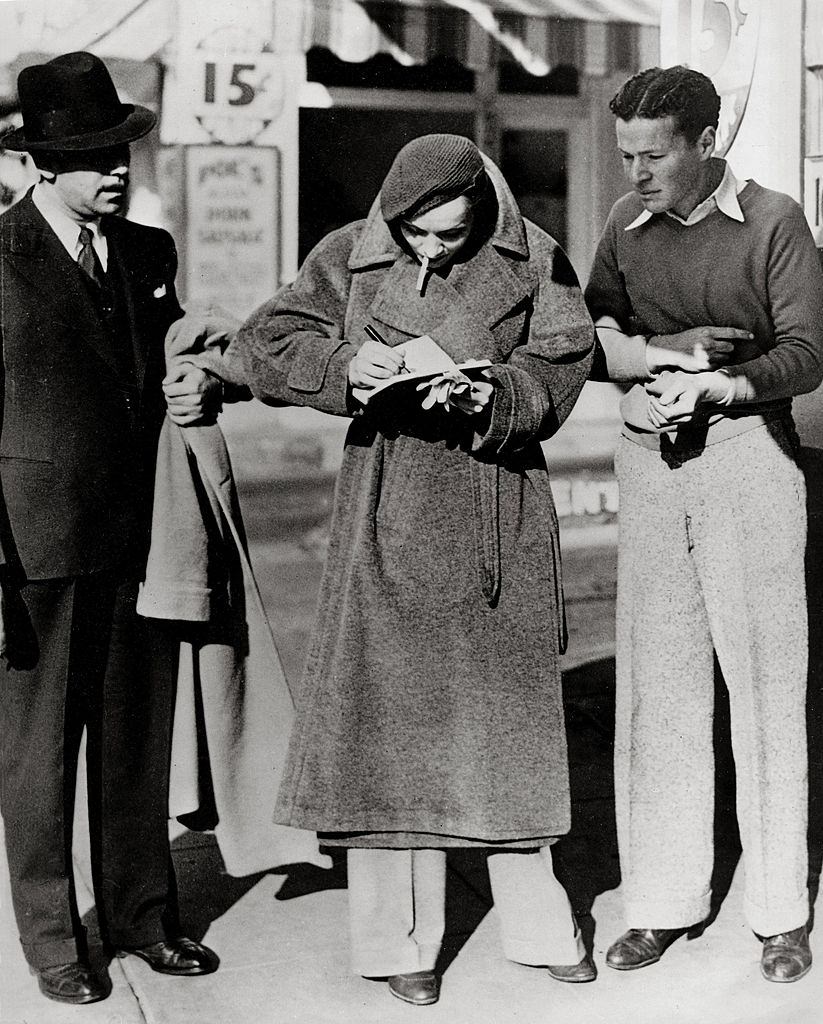 #30 Marlene Dietrich signing autographs at Hollywood Boulevard, 1933.