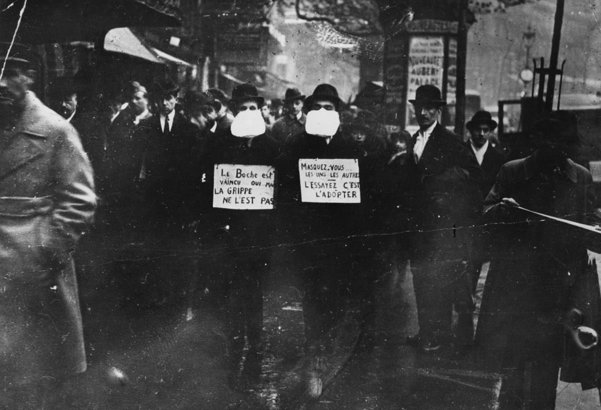 #3 Two men wearing and advocating the use of flu masks in Paris during the Spanish flu epidemic which followed World War I.