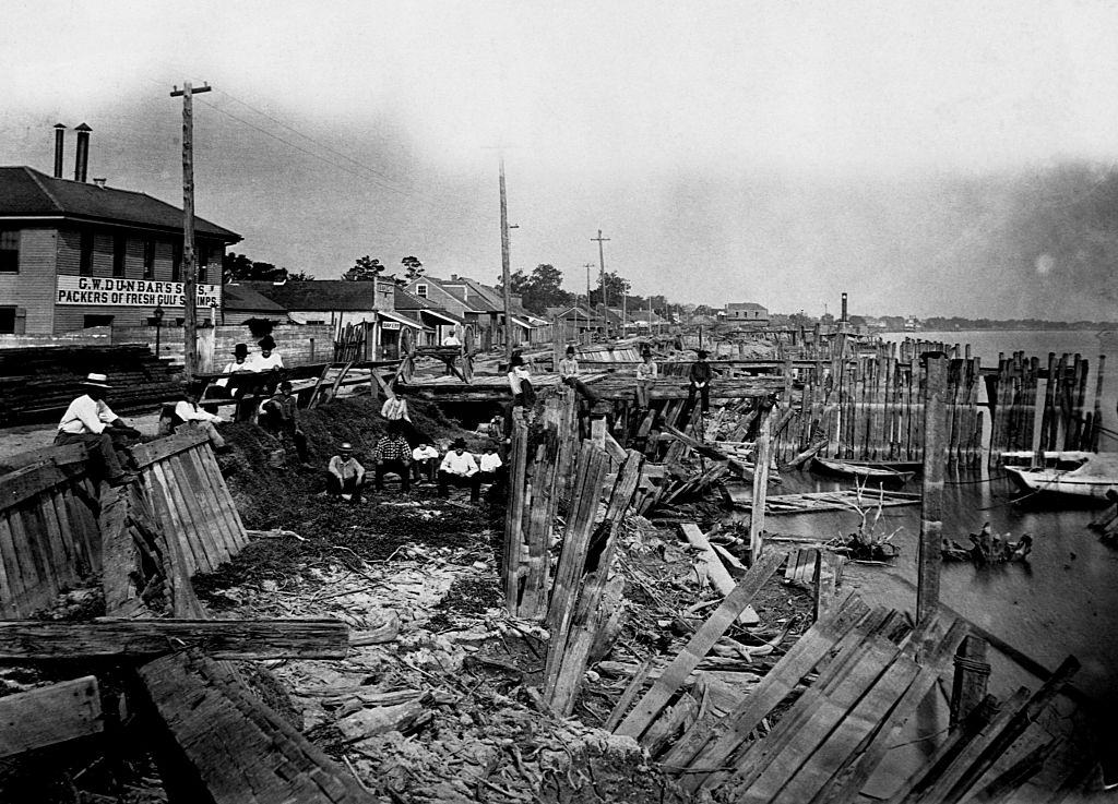 #15 A group of men sit on weather-beaten wharves between Piety and Desire Streets, New Orleans, August 1881.