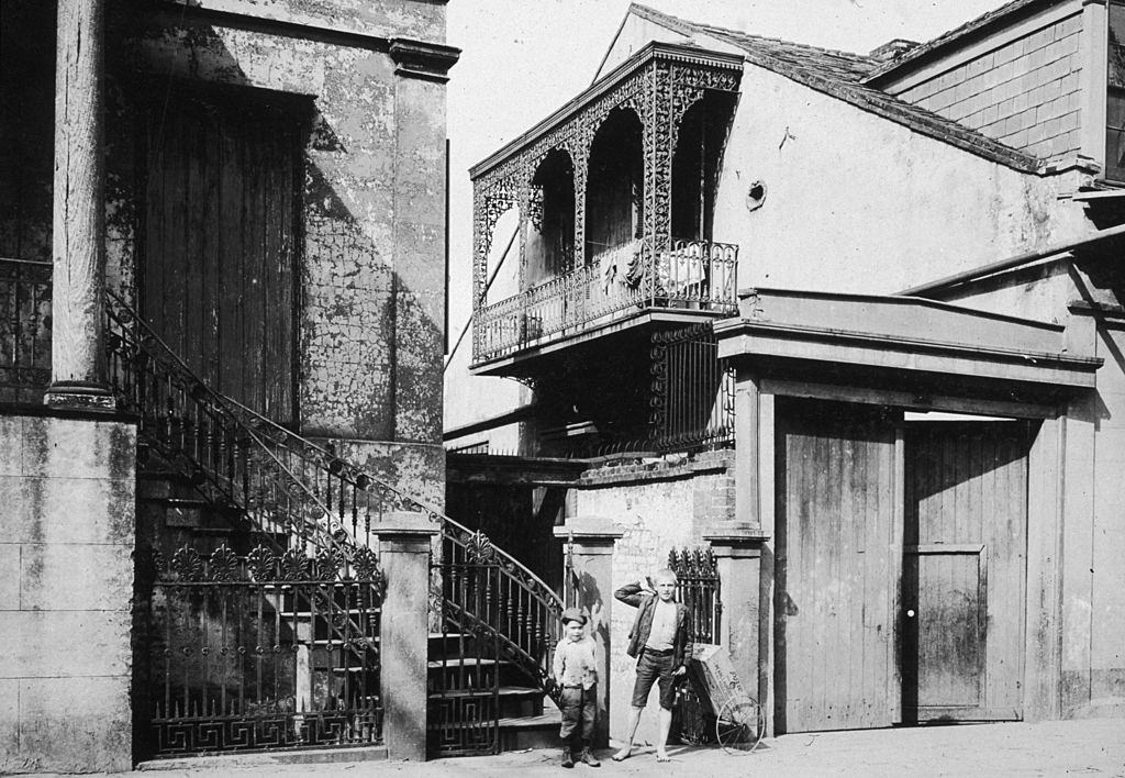 #29 Two young boys stood by the side entrance to the Old Beauregard Home in the French Quarter of New Orleans, 1899.