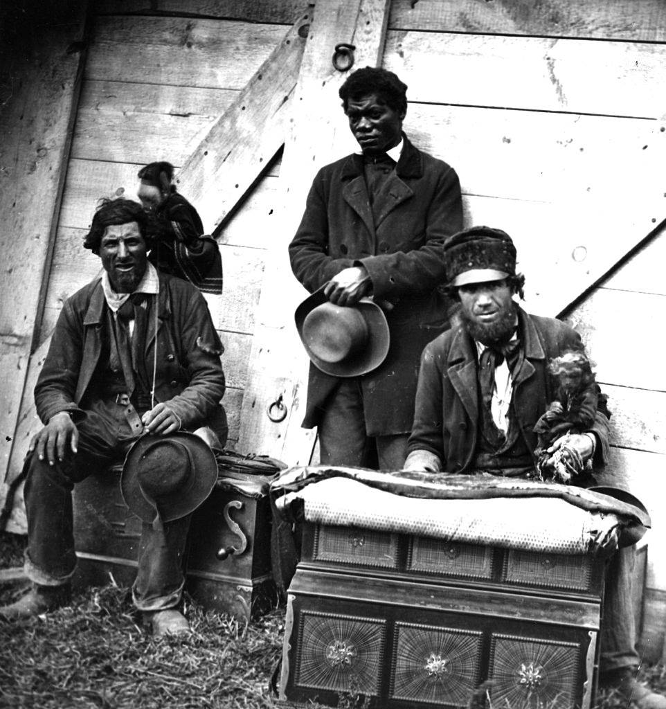 #26 Itinerant street musicians with organs and monkeys, 1860s.
