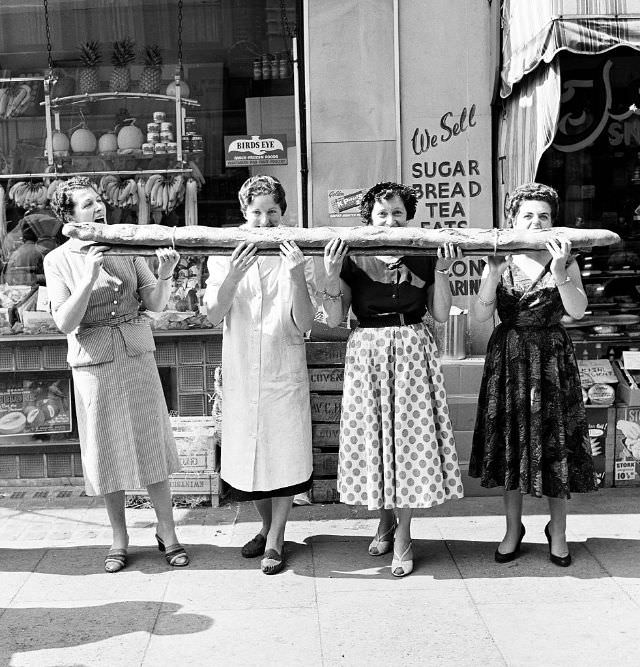 #2 Four women sharing a 9-foot-long baguette, 1955.