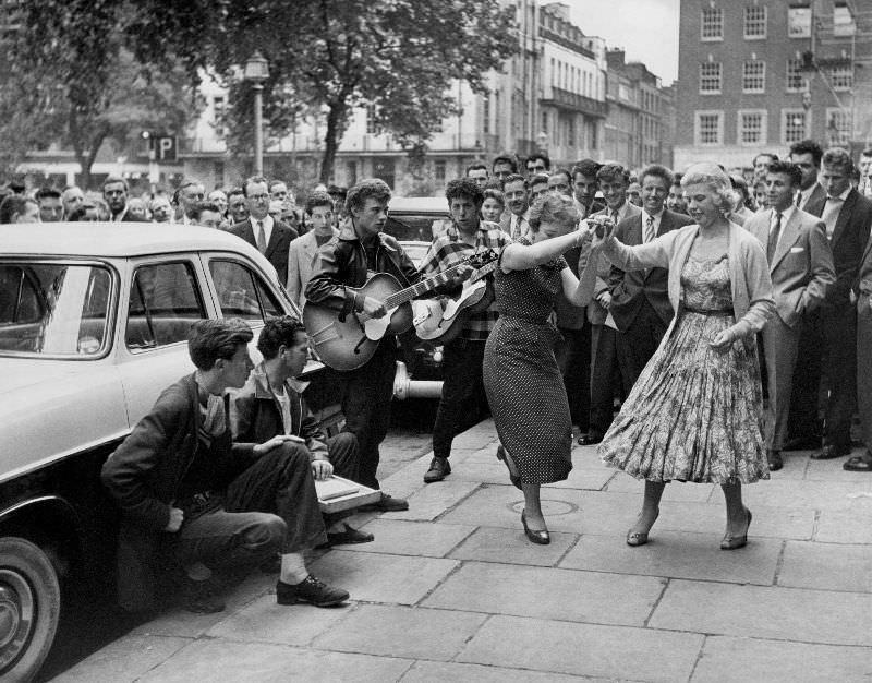 #27 A group playing and jiving in the street at a fair, 1957.