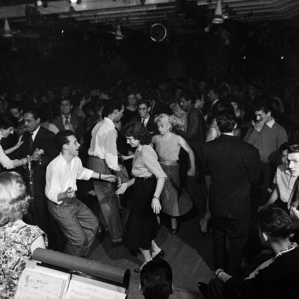 #10 Londoners enjoy the Soho nightlife in 1956.