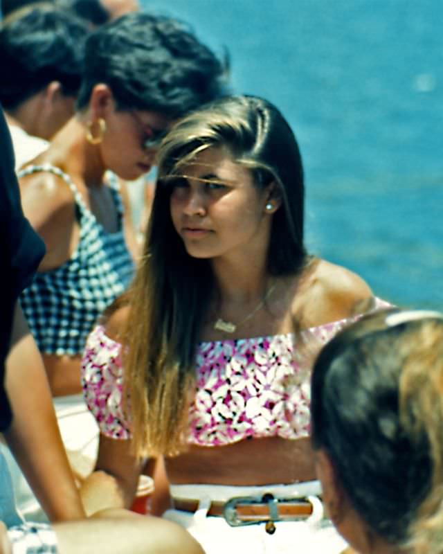 #28 Girl was sitting by the waterfront during the annual festival in West Palm Beach in the midst of the crowds, 1990