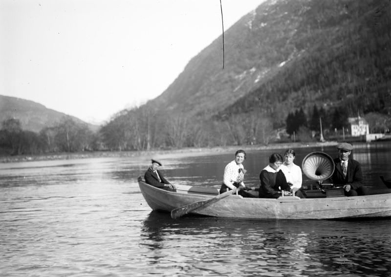 #16 Five people in a rowing boat downstream on the river Jølstra from Hafstad Hotel in Førde