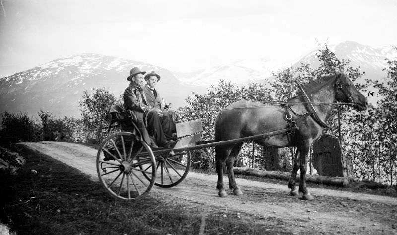 #50 Two men traveling alongside Jølstravatnet lake.
