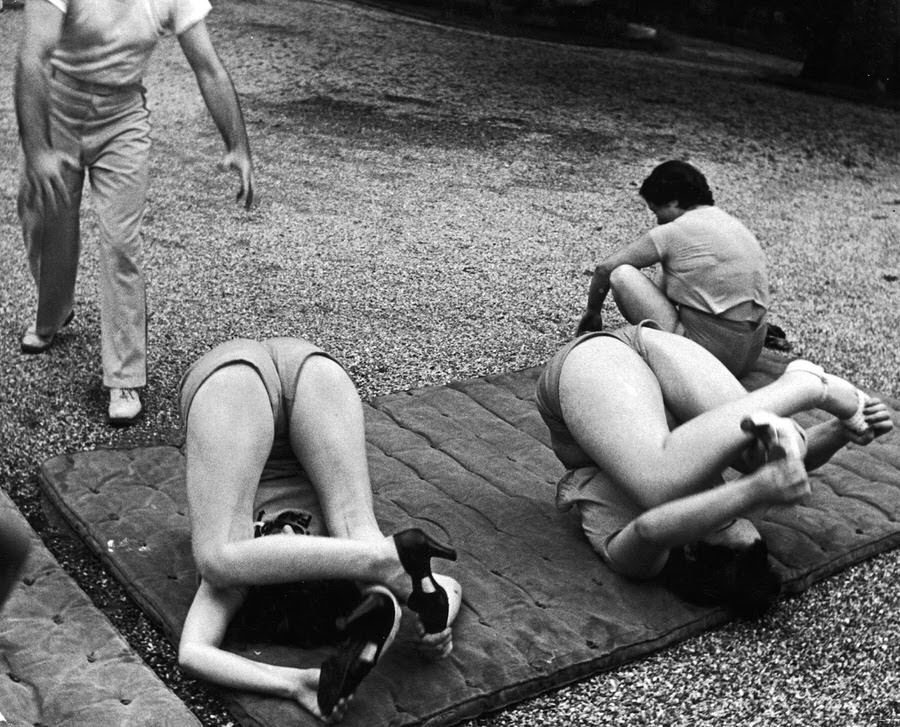 Steve Finan directs mat exercises calculated to reduce hips and remove “widow’s humps” which form at back of neck.