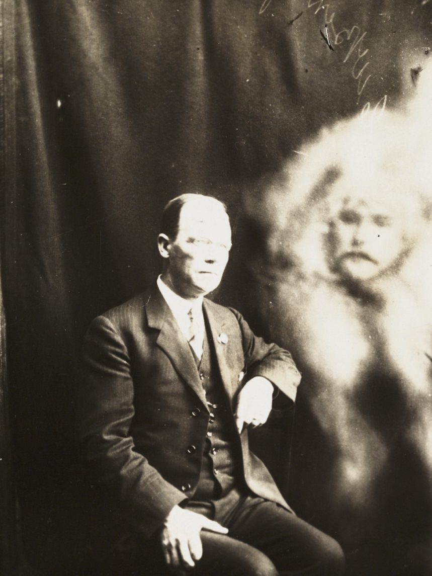 #12 A man’s face appears next to a man sitting.